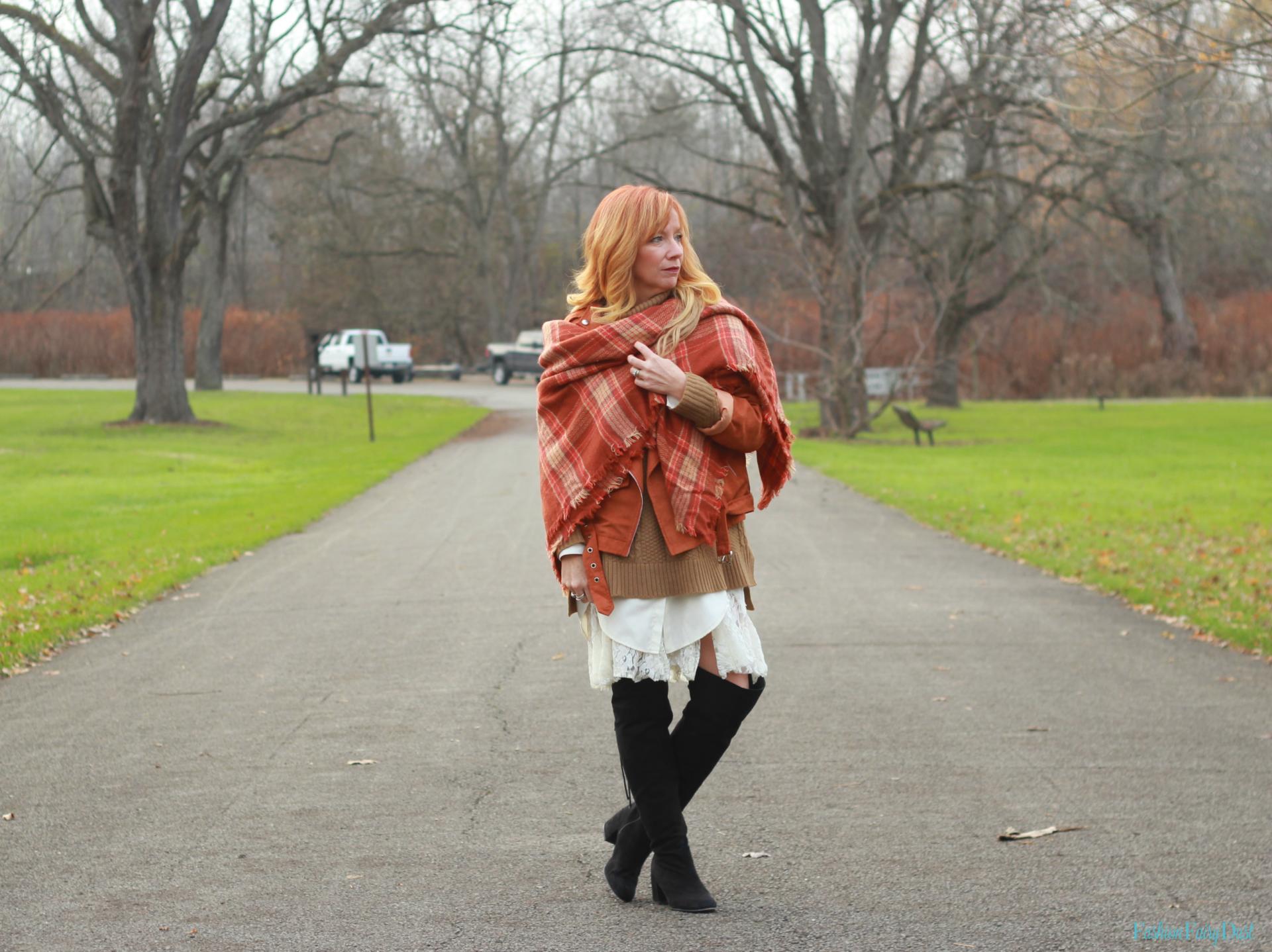 Orange plaid blanket scarf, moto jacket and cowl neck sweater.